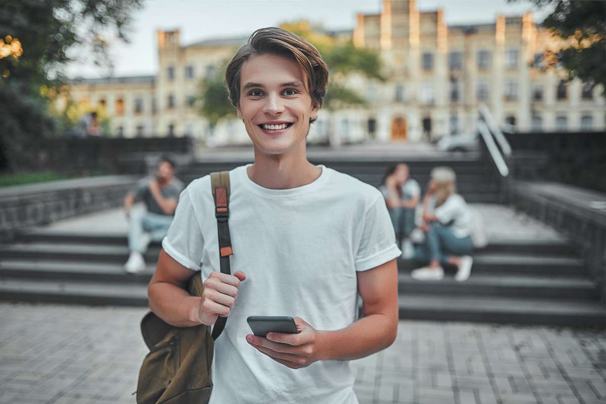Young man with phone and backpack